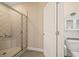 Bathroom featuring a glass shower with white tiled walls and floors with a white toilet at 2020 Rivermont Way, Roswell, GA 30076