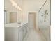 Bathroom featuring marble tiled floors, double sinks and granite counter, with a glass shower at 2020 Rivermont Way, Roswell, GA 30076