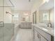 Bathroom featuring marble floors, granite counters, double sinks, a large soaking tub and a glass door shower at 2020 Rivermont Way, Roswell, GA 30076