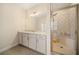 Bright bathroom featuring a granite counter, double sinks, and tiled shower with glass doors at 2020 Rivermont Way, Roswell, GA 30076