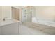 Bathroom featuring marble tiled floors, double sinks and granite counter, with a large shower and soaking tub at 2020 Rivermont Way, Roswell, GA 30076