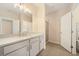 Bright bathroom with granite counters, double sinks, a tiled floor, and a glass door shower at 2020 Rivermont Way, Roswell, GA 30076