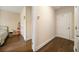 A hallway view into a bedroom with hardwood floors and ample closet space at 2020 Rivermont Way, Roswell, GA 30076