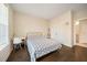 A bright bedroom with hardwood floors, a desk, and an attached bath at 2020 Rivermont Way, Roswell, GA 30076