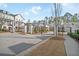Gated entrance into the townhome community featuring brick pillars, metal gates and mature landscaping at 2020 Rivermont Way, Roswell, GA 30076