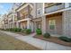 Charming exterior view of the townhome with brick accents and well-maintained landscaping at 2020 Rivermont Way, Roswell, GA 30076