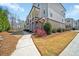 Exterior townhome view showing a sidewalk and well-manicured lawns at 2020 Rivermont Way, Roswell, GA 30076