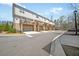Street view of townhomes, each with a garage and private balcony at 2020 Rivermont Way, Roswell, GA 30076