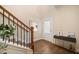 A well-lit foyer with wood floors and a charming staircase at 2020 Rivermont Way, Roswell, GA 30076