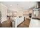 Open concept kitchen with island seating, stainless steel appliances, and hardwood floors throughout at 2020 Rivermont Way, Roswell, GA 30076