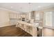 Bright kitchen with island seating, stainless appliances, and hardwood floors in a modern home at 2020 Rivermont Way, Roswell, GA 30076