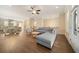 An open-concept living room and dining area with hardwood floors and comfortable gray sofa at 2020 Rivermont Way, Roswell, GA 30076