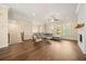 Bright living room with hardwood floors, fireplace, and a comfortable gray sectional sofa at 2020 Rivermont Way, Roswell, GA 30076