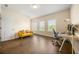 Bright office space with hardwood floors, desk, and comfortable yellow sofa at 2020 Rivermont Way, Roswell, GA 30076