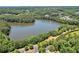 Aerial view of a lake surrounded by lush greenery, with glimpses of residential areas and a winding road at 429 Argonne Ter, Canton, GA 30115