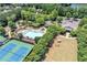 Aerial view of community pool and tennis courts, alongside a clubhouse and an open grassy area at 429 Argonne Ter, Canton, GA 30115