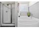 Bright bathroom featuring a soaking tub, separate shower, and white paneled walls at 429 Argonne Ter, Canton, GA 30115