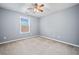 Comfortable bedroom features neutral carpet, ample natural light, and a ceiling fan at 429 Argonne Ter, Canton, GA 30115
