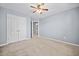 Cozy bedroom boasts neutral carpeting, a ceiling fan, and a double door closet at 429 Argonne Ter, Canton, GA 30115