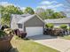 Charming home with a two-car garage, well-manicured lawn, and a cozy outdoor seating area at 429 Argonne Ter, Canton, GA 30115