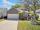 Beautiful home featuring a well-kept lawn, landscaping, a two car garage, and cozy outdoor seating at 429 Argonne Ter, Canton, GA 30115