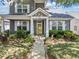Inviting home exterior with a well-kept lawn, colorful flowerbeds, and a bright yellow front door at 429 Argonne Ter, Canton, GA 30115