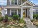 Close-up of a charming front porch featuring decorative columns and a bright yellow front door at 429 Argonne Ter, Canton, GA 30115