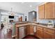 Spacious kitchen with stainless steel dishwasher overlooking a dining area and living room at 429 Argonne Ter, Canton, GA 30115