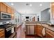Modern kitchen boasts stainless appliances, wood cabinets, and open to living area at 429 Argonne Ter, Canton, GA 30115
