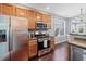 Well-equipped kitchen with stainless steel appliances and wood cabinets overlooking dining area at 429 Argonne Ter, Canton, GA 30115