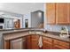 Spacious kitchen with stainless dishwasher and wood cabinets, open to the cozy living space at 429 Argonne Ter, Canton, GA 30115