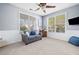 Comfortable living room with a cozy gray sofa, two large windows, and neutral carpet at 429 Argonne Ter, Canton, GA 30115