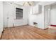 Well-lit room with a ceiling fan, hardwood floors, and a large window at 814 Welch Sw St, Atlanta, GA 30310