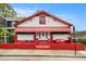 Charming home with white and red exterior, awning, landscaped front yard, and inviting entryway at 814 Welch Sw St, Atlanta, GA 30310