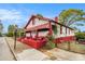 Charming home with white and red exterior, awning, landscaped front yard, and fenced yard at 814 Welch Sw St, Atlanta, GA 30310