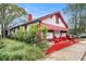 Charming home with white and red exterior, awning, and landscaped front yard at 814 Welch Sw St, Atlanta, GA 30310