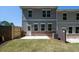 View of the backyard of the townhouse featuring a small yard and patio at 1600 Ruskin Way, Marietta, GA 30062