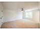 Large, empty bedroom with neutral carpet and ceiling fan at 1600 Ruskin Way, Marietta, GA 30062