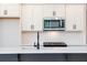 Close-up of the kitchen island with modern appliances and fixtures at 1600 Ruskin Way, Marietta, GA 30062
