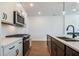 Modern kitchen featuring stainless steel appliances, white cabinets, and stylish backsplash at 1600 Ruskin Way, Marietta, GA 30062