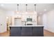 Spacious kitchen with a large island and stylish pendant lighting at 1600 Ruskin Way, Marietta, GA 30062