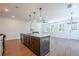 Modern kitchen with stainless steel appliances, island, and open to a bright living area at 1600 Ruskin Way, Marietta, GA 30062