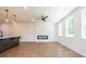 Living room featuring modern fireplace, ceiling fan, and hardwood floors at 1600 Ruskin Way, Marietta, GA 30062