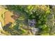 Aerial view of the property highlighting the house, pond, and surrounding landscape at 2442 Lower Union Hill Rd, Canton, GA 30115