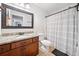 Bathroom featuring a wood vanity with granite countertop, a modern mirror and a shower with a striped curtain at 2442 Lower Union Hill Rd, Canton, GA 30115