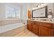 Bathroom featuring a soaking tub, a double vanity, and granite countertops at 2442 Lower Union Hill Rd, Canton, GA 30115