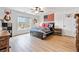 Bright bedroom with hardwood floors, a bed, an American flag and a window offering an outdoor view at 2442 Lower Union Hill Rd, Canton, GA 30115