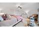 Light-filled bedroom boasts hardwood floors, a comfortable bed, and charming decor with a white ceiling fan at 2442 Lower Union Hill Rd, Canton, GA 30115