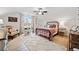 Cozy bedroom features an iron bed, a large window, and a neutral rug over wood flooring at 2442 Lower Union Hill Rd, Canton, GA 30115