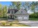 Charming two-story home with attached two-car garage and landscaped front yard at 2442 Lower Union Hill Rd, Canton, GA 30115